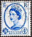 UNITED KINGDOM - CIRCA 1953: A 4p blue and white English used postage stamp bearing a portrait of Queen Elizabeth II