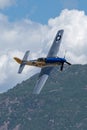 P-51 Mustang Performing Aerobatics at Hill AFB in blue sky above Wasatch Mountains
