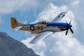 P-51 Mustang Performing Aerobatics at Hill AFB in blue sky above Wasatch Mountains