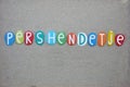 PÃ«rshÃ«ndetje, albanian word meaning hello composed with multi colored stone letters over beach sand Royalty Free Stock Photo