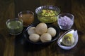 Paani Puri, served on a black plate, along with the ingredients