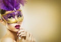 Paarty woman swearing golden mask on light backgound Royalty Free Stock Photo