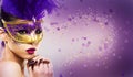 Paarty woman swearing golden mask on light backgound Royalty Free Stock Photo