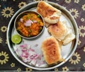 Paav Bhaji plate served with chopped onions and lemon slice. Royalty Free Stock Photo