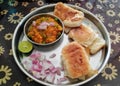 Paav Bhaji plate served with chopped onions and lemon slice. Royalty Free Stock Photo