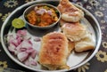 Paav Bhaji plate served with chopped onions and lemon slice. Royalty Free Stock Photo