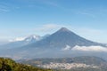 Pacaya Volcano hike tour. Panoramic view of volcano Fuego Acatenango and agua with village below