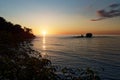 Pacific coast of Costa Rica in Central America, evening sunset with palm trees, ocean and clouds on the red sky Royalty Free Stock Photo