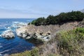 Pacific Coast Highway through Big Sur California on a sunny day, waves crashing against shoreline Royalty Free Stock Photo