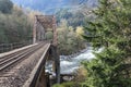 Train tressel crossing river in wilderness Royalty Free Stock Photo