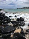 Pacific Ocean Waves and Lava Rocks at Kealia Beach on Kauai Island in Hawaii.