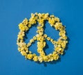 Pacific symbol is made of yellow flowers on a blue background. The concept of the flag of Ukraine. Support and peace in  Ukraine. Royalty Free Stock Photo