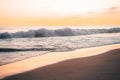 Pacific waves and sandy beach at sunset