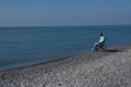 Pacified caucasian woman in a wheelchair on the seashore.