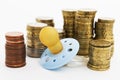 Pacifier with hard money in background Royalty Free Stock Photo