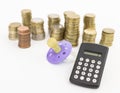 Pacifier with hard money and pocket calculator Royalty Free Stock Photo