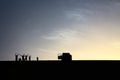 A pack of adventurers salute from the top of a grand sand dune while enjoying a beautiful summer sunset in Dakhla Oasis, Egypt