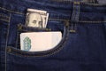 A pack of American hundred-dollar bills and Russian rubles in a pocket of blue jeans. Money in pocket cash Royalty Free Stock Photo