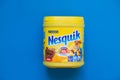Pack of chocolate and cacao drink Nesquik by Nestle on blue background