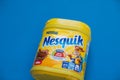 Pack of chocolate and cacao drink Nesquik by Nestle on blue background