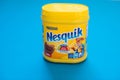 Pack of chocolate and cacao drink Nesquik by Nestle on blue background