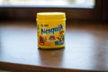 Pack of chocolate and cacao drink Nesquik by Nestle on wood background