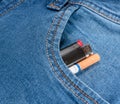 Pack of cigarettes and lighter in pocket jeans Royalty Free Stock Photo