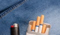 Pack of cigarettes and lighter in pocket jeans Royalty Free Stock Photo