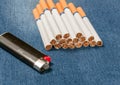 Pack of cigarettes and lighter in pocket jeans Royalty Free Stock Photo