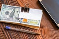 Pack of dollars phone pen and paper sticker for your text on wooden background