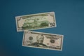 Pack of fifty dollars banknotes isolated on blue background Royalty Free Stock Photo