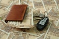 Pack of Indian currency notes in wallet with car key on the 10 rupee currency notes