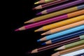 A pack of multicolored pencils on a dark background