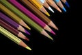 A pack of multicolored pencils on a dark background