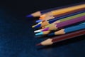A pack of multicolored pencils on a dark gray background Royalty Free Stock Photo