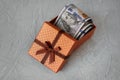 one hundred dollars banknotes in brown box on gray concrete background Royalty Free Stock Photo