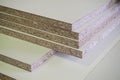 A pack of parts of a particleboard in the furniture manufacturing.