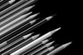 A pack of pencils on a dark background close-up. Black and white