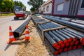 Pack of polymeric HDPE water pipes and few warning traffic cones Royalty Free Stock Photo