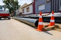 Pack of polymeric HDPE water pipes and few warning traffic cones Royalty Free Stock Photo