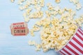 Pack of popcorn at the cinema and two movie tickets on a blue background Royalty Free Stock Photo