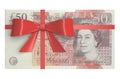 Pack of 50 pound sterling banknotes with red bow, gift concept.