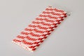 Pack of red and white striped disposable paper straws for party cocktails Royalty Free Stock Photo