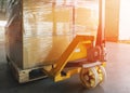 Package Boxes on Pallet with Hand Pallet Truck. Shipment Delivery. Cargo Warehouse Logistics. Royalty Free Stock Photo