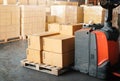 Package Boxes on Pallets and Forklift Pallet Jack. Shipment Boxes, Supply Chain, Supplies Warehouse Shipping Logistics. Royalty Free Stock Photo