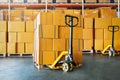 Package Boxes Stacked on Pallets with Hand Pallet Truck. Storehouse, Distribution, Supply Chain. Supplies Warehouse Shipping. Royalty Free Stock Photo