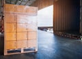 Package Boxes Stacked on Wooden Pallets Loading into Container Trucks. Distribution Supplies Warehouse Shipping. Royalty Free Stock Photo