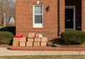 Package delivery on doorstep. Boxes and postal delivery on modern brick home doorstep Generative AI