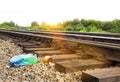 A package with garbage on the railway thrown out from the window of the train by passengers, pollution, debris and the railway