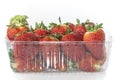 Package of strawberries on a white background, close up, isolated.